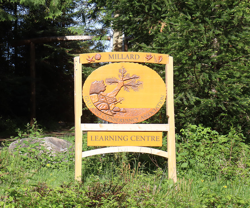 Sign on Porlier Pass Road, entrance to the Millard Learning Centre on Galiano Island